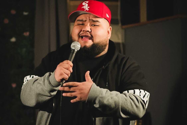 ComedyFest LA 2024 Headliner: KEN FLORES is a comedian performing on stage at a comedy festival in Bellflower, CA.